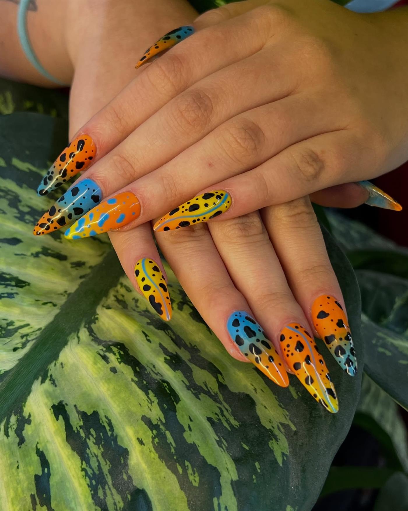 Manos con uñas de rana sobre una hoja